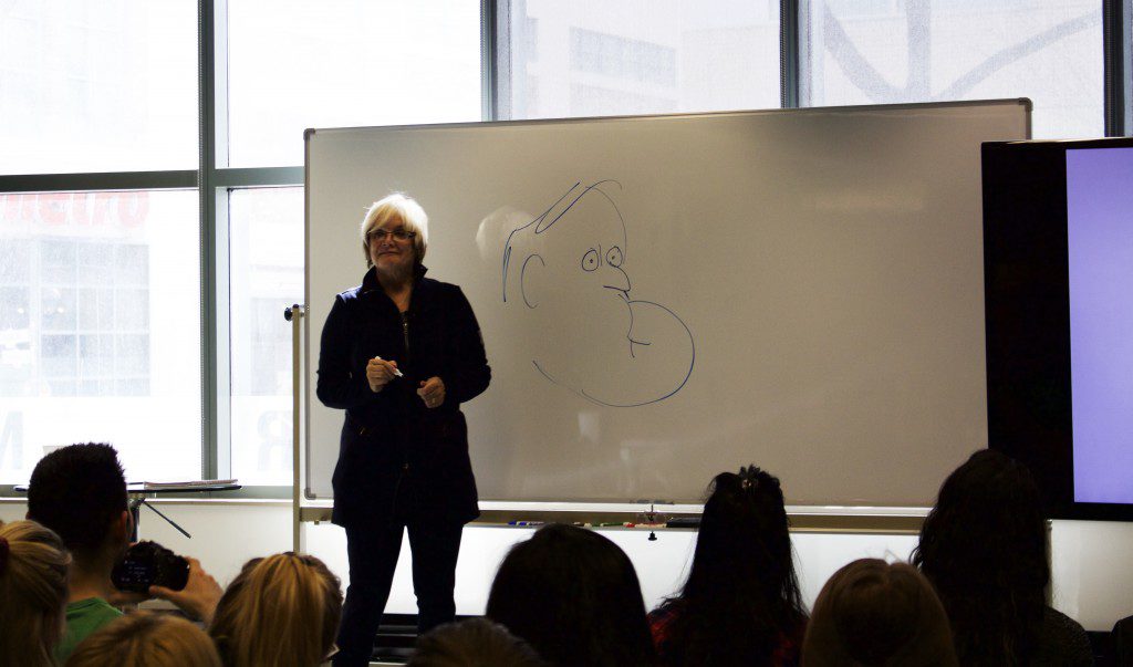 Dewar providing an example of her Brian Mulroney caricatures. (Photo: Robert Liwanag)