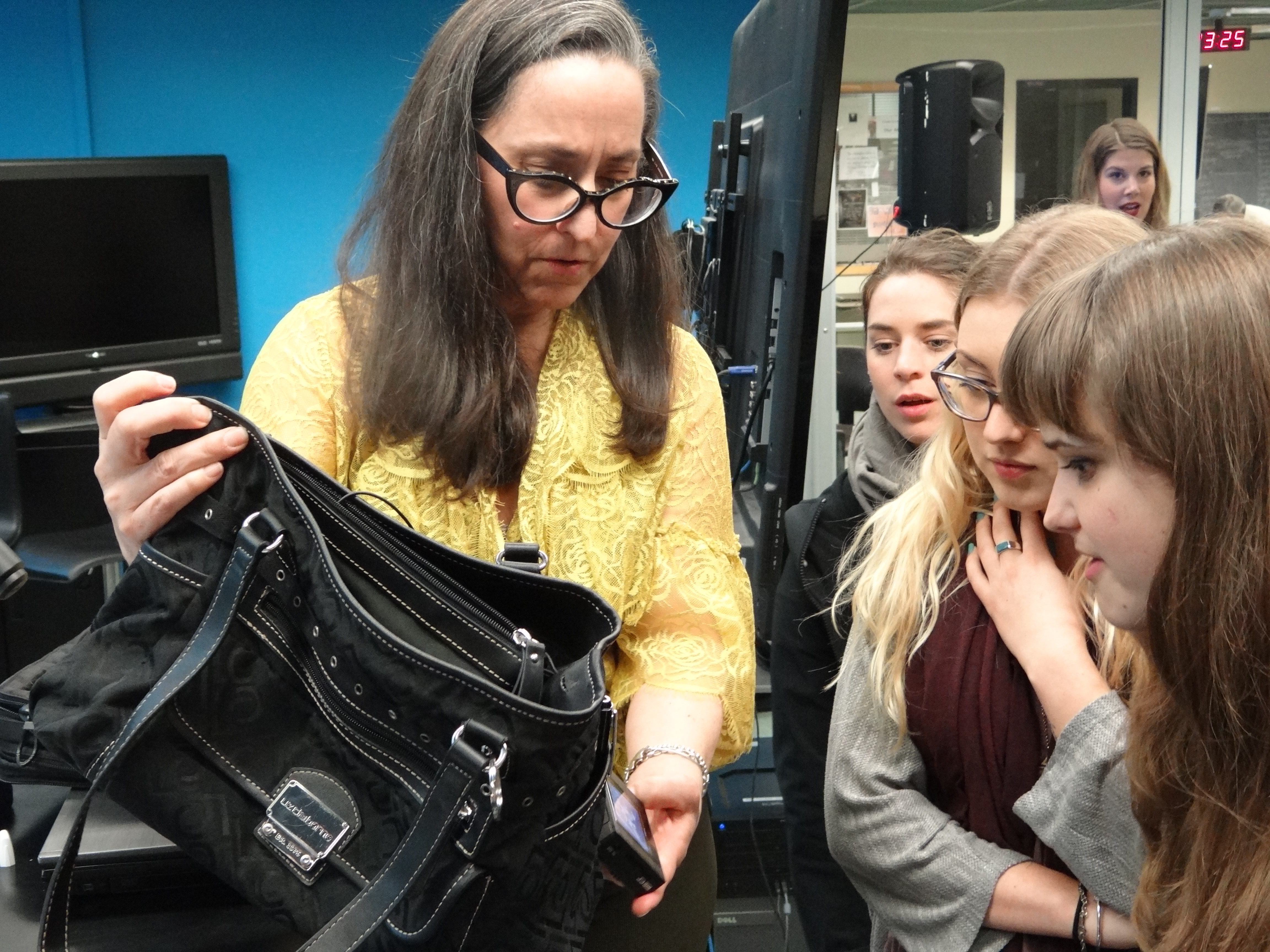 Laurie Few gives students a demonstration on hidden camera techniques. 